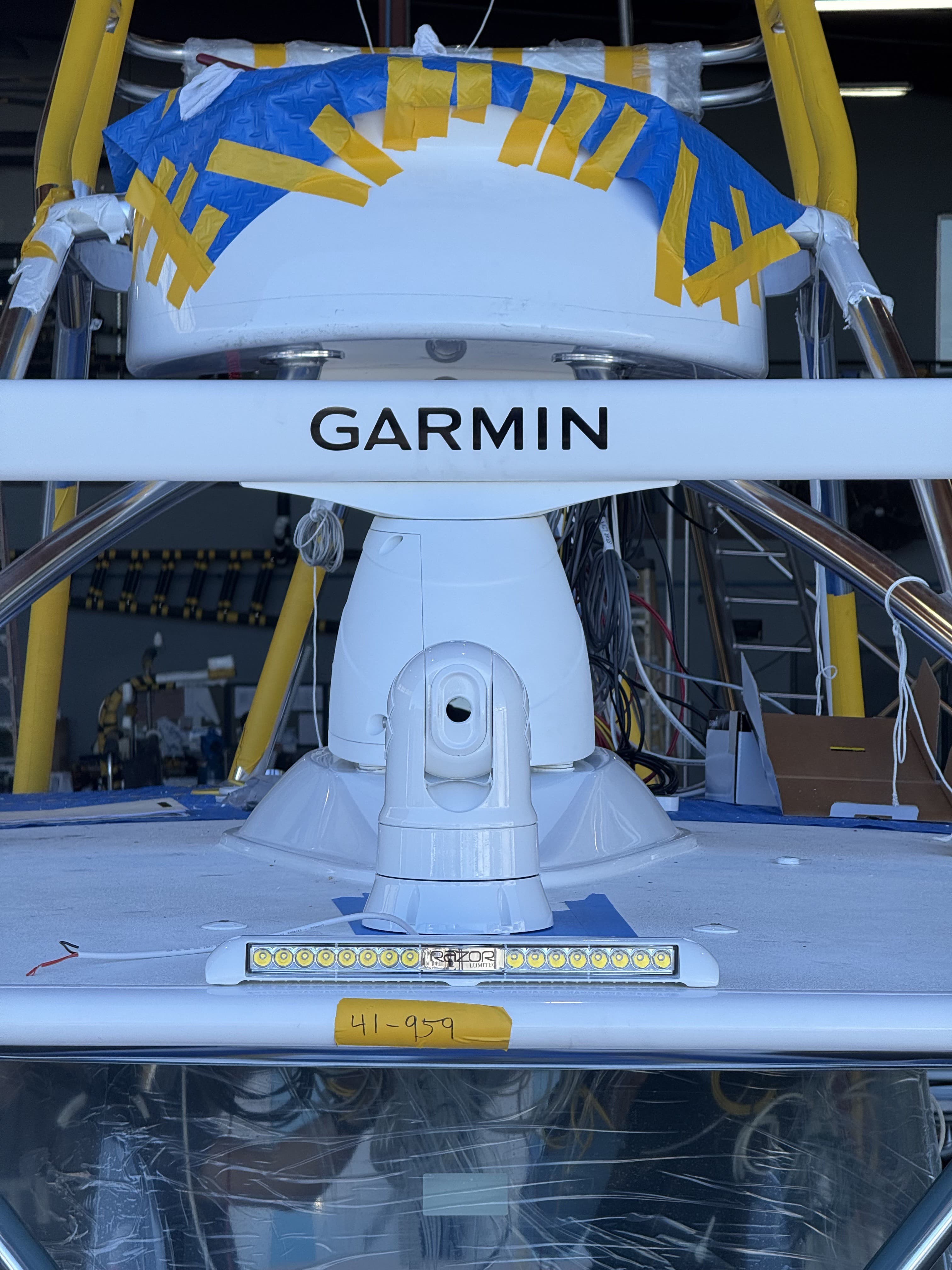 Radar dome and LED light bar installed on a tower, mid-install
