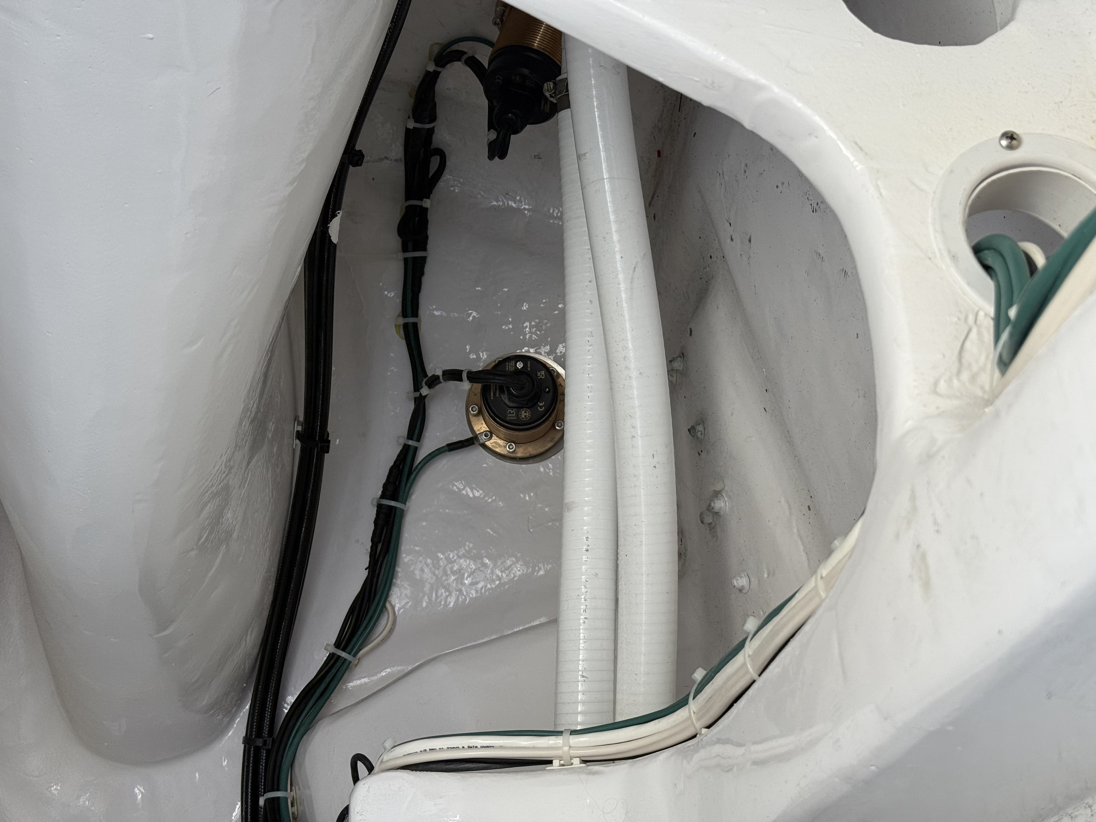 Transducer and thru-hull fitting with routed cabling inside the hull